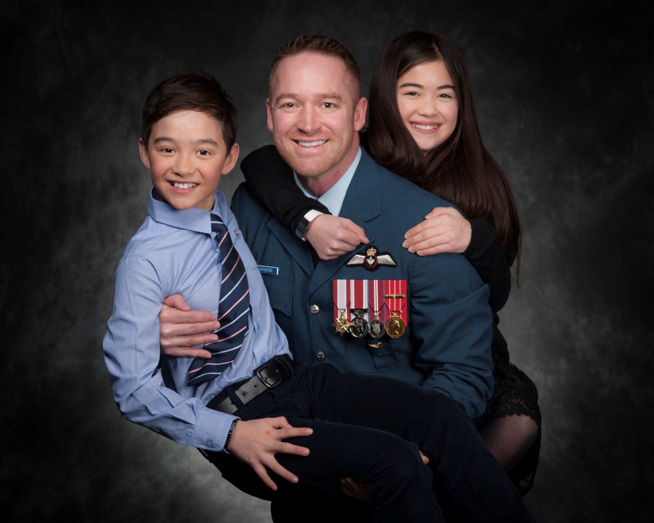 Ray with his kids prior to his retirement in 2020.