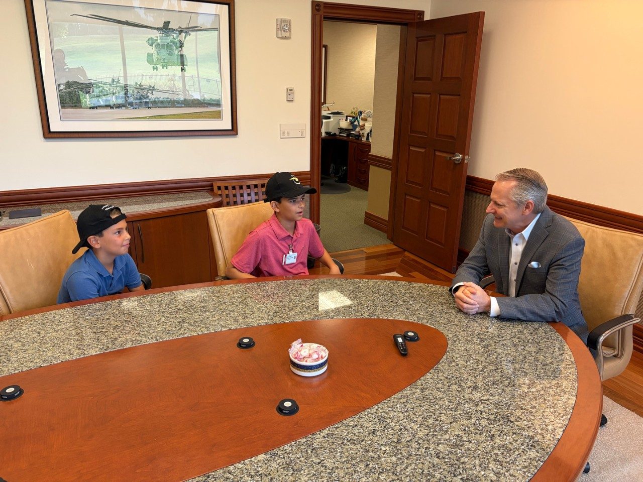 Sawyer and Parker Waldman, sons of Essex Industries CEO Evan Waldman, visit Sikorsky Vice President and General Manager Rich Benton at the Sikorsky offices in Stratford, Conn., Aug 20, 2026. The boys were rescued by Missouri National Guard crews in Sikorsky-made Black Hawk helicopters when their summer camp flooded and they, along with approximately 200 other children and adults, had to be evacuated. 