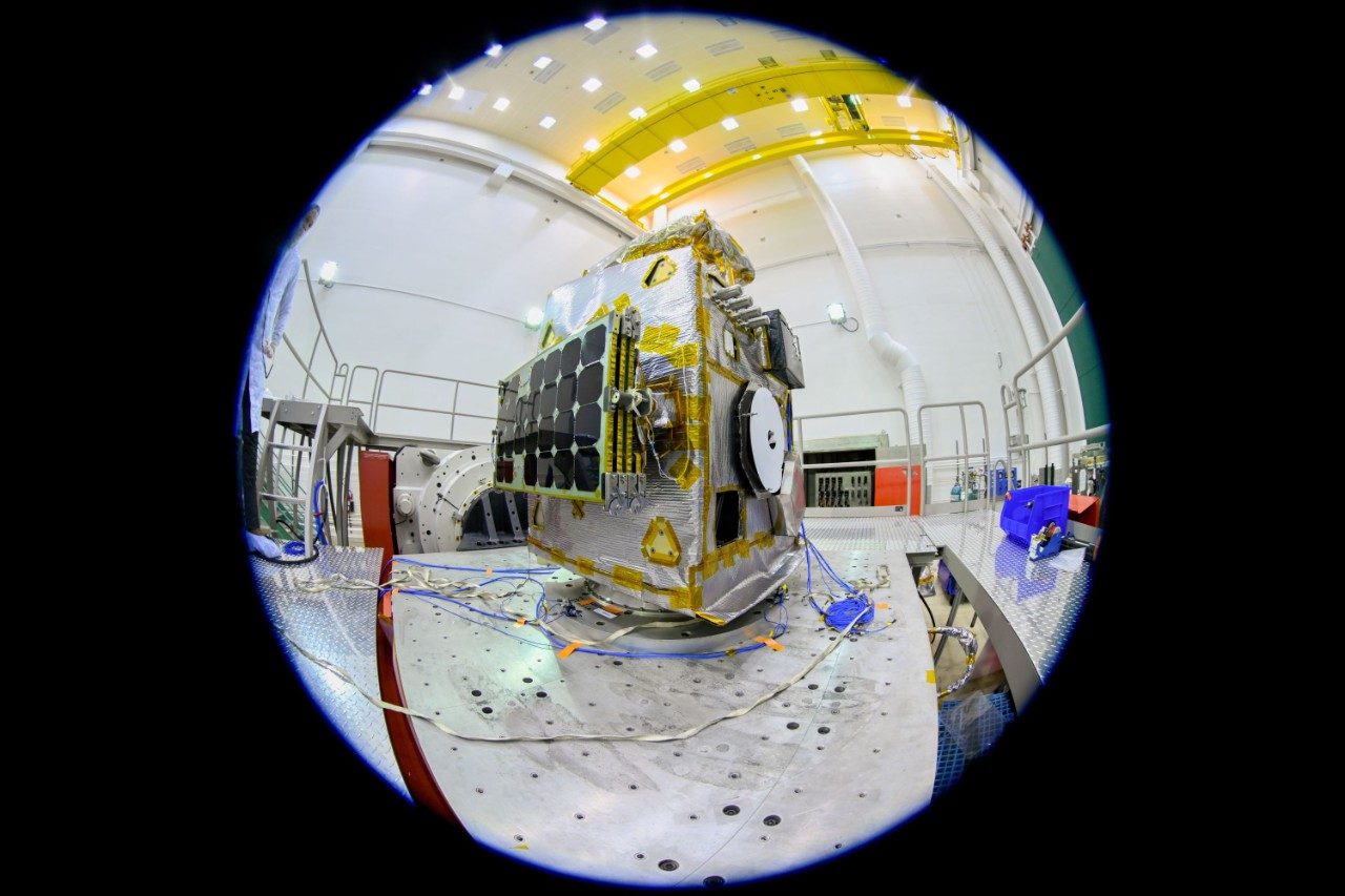 a fisheye lens view of Lunar Trailblazer on its test stand ahead of environmental testing at a Lockheed Martin Space facility