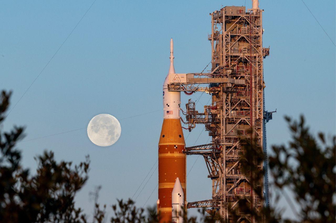The Moon rises over NASA's Orion, built by Lockheed Martin, atop the space launch system rocket during wet dress rehearsal for Artemis II.